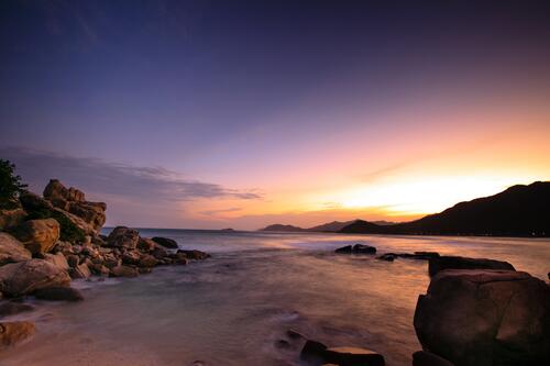 A picturesque landscape at sunset by a rocky seashore