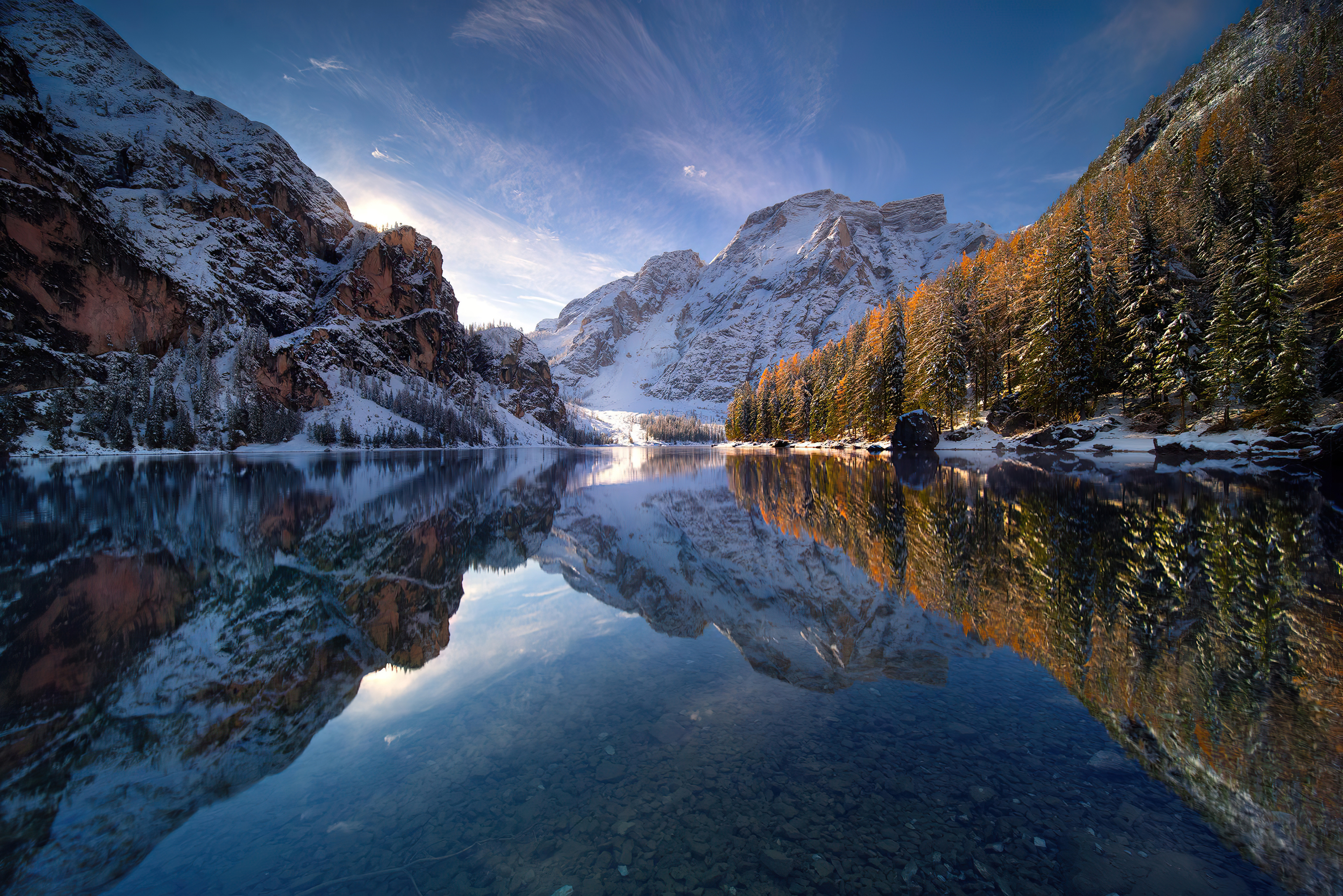 The morning lake reflects the mountain landscape