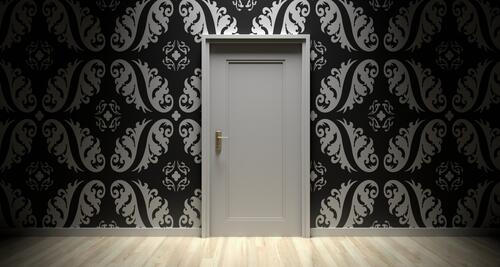 Gray door with dark wallpaper