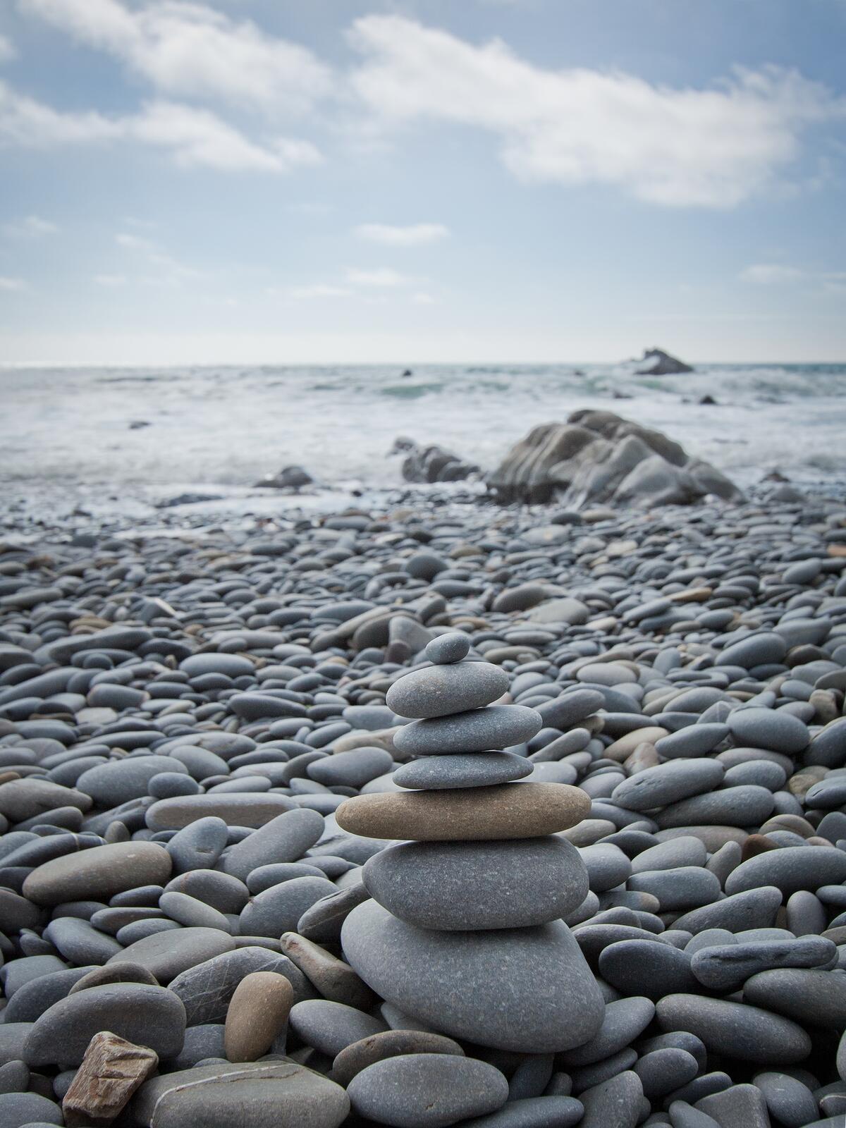 Pebbles stacked on top of each other on the seashore