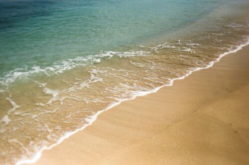 Sandy seashore with clear water