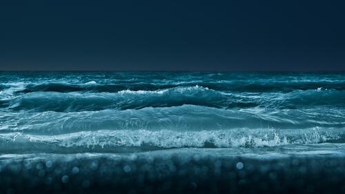 Big waves on the seashore at night time