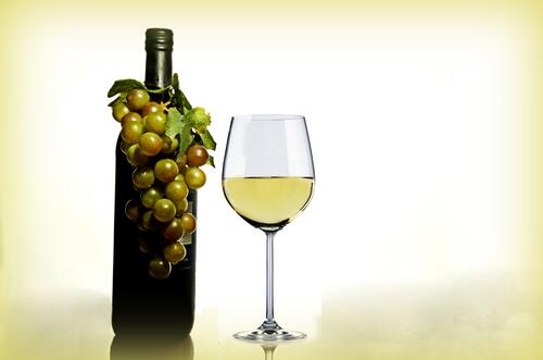 A bottle of white wine with a glass