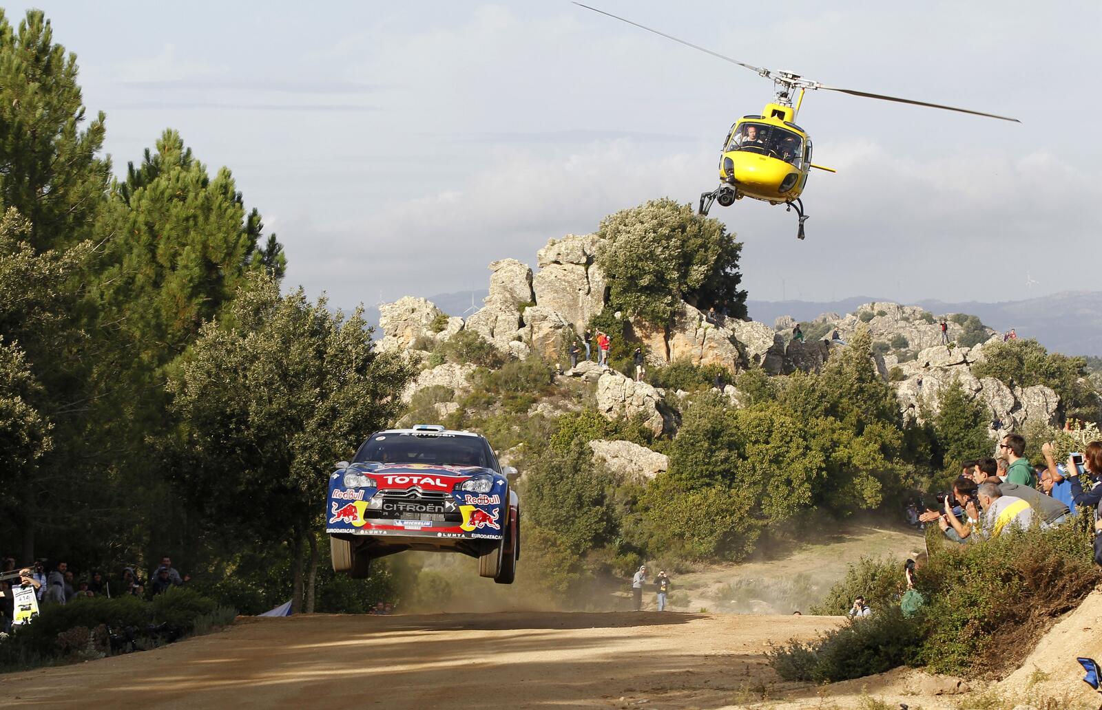 Бесплатное фото Вертолет преследует спортивную машину на ралли