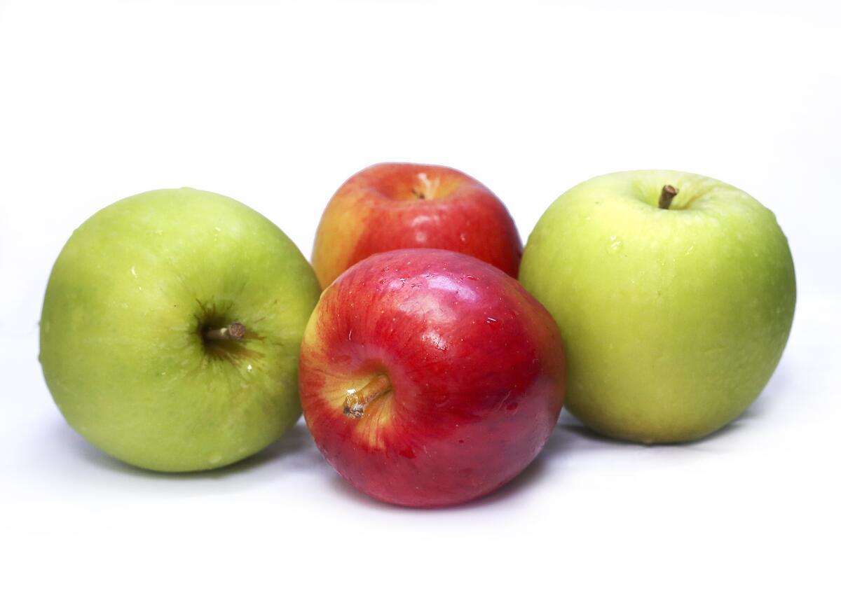 Two varieties of apples on a white background