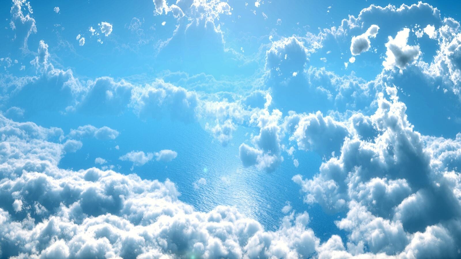 Бесплатное фото Полет над облаками сквозь которые виднеется океан