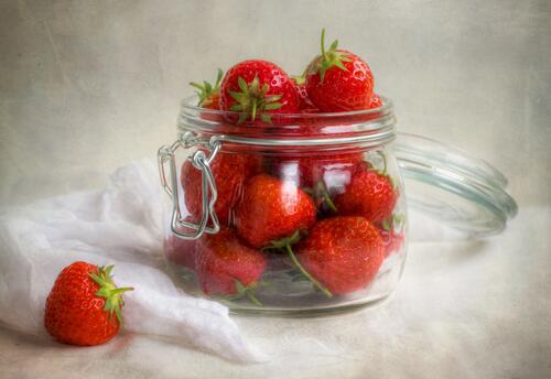 Red strawberries in a jar