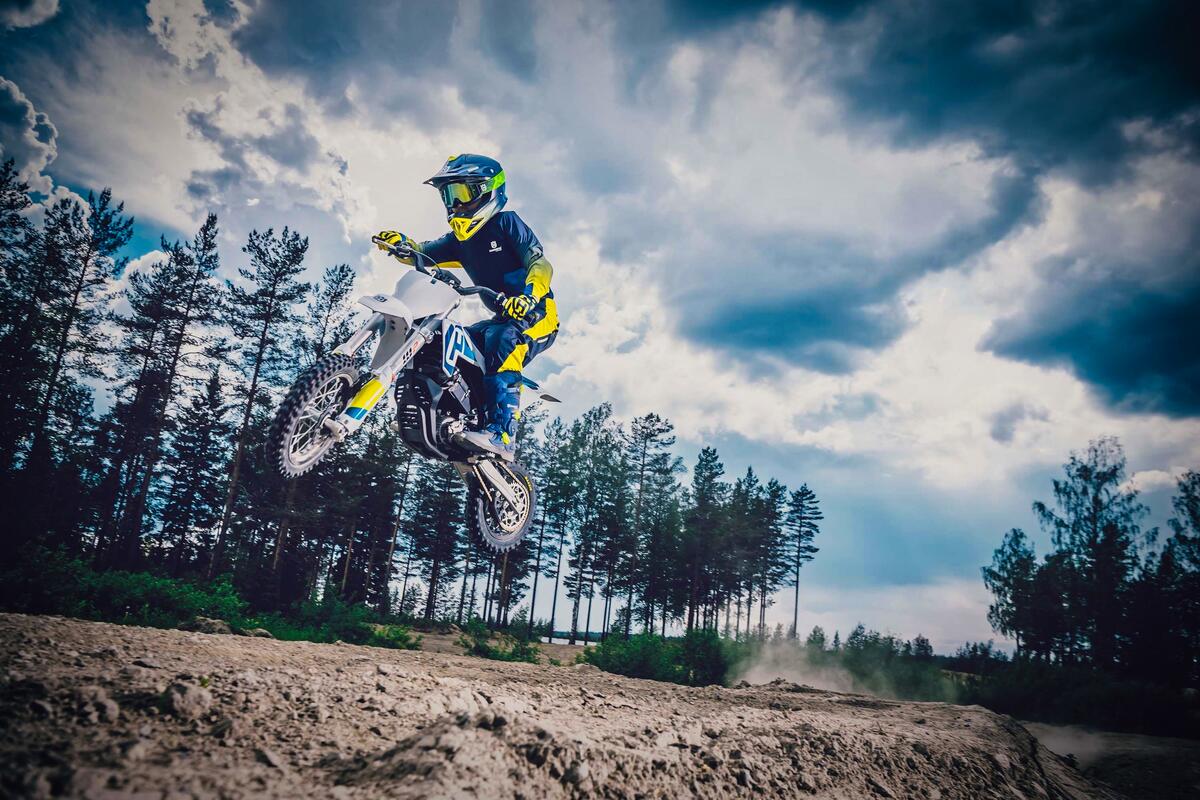 A teenager on a pit bike in a jump