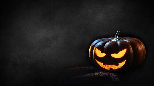 Spooky Halloween pumpkin on a dark background