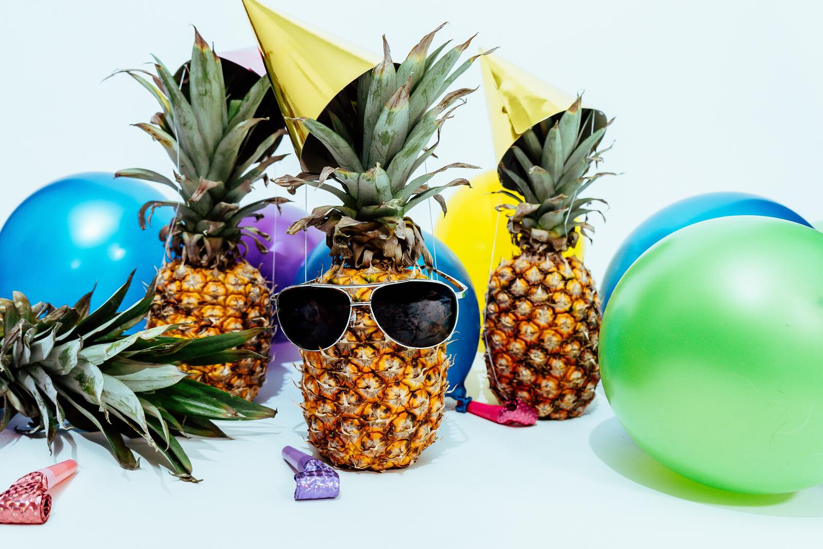 Free photo Pineapples in sunglasses at the disco.