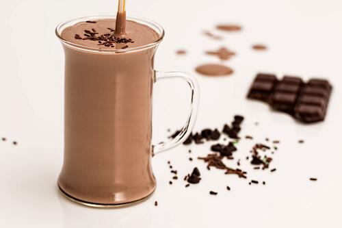 Mug with chocolate shake and chocolate bar