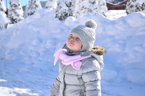 The little girl is enjoying the winter
