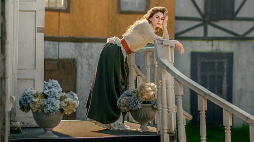 Model Anastasia Orlovskaya standing on the porch