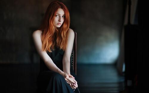 Red-haired girl in a black dress.